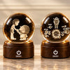 DOMIRA crystal globes and gift box on a marble shelf