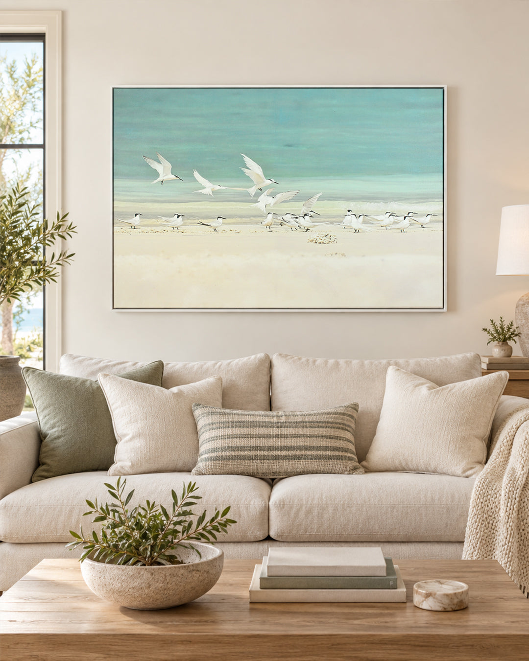 A Flurry of Wings white bird wall art above a sofa in a living room