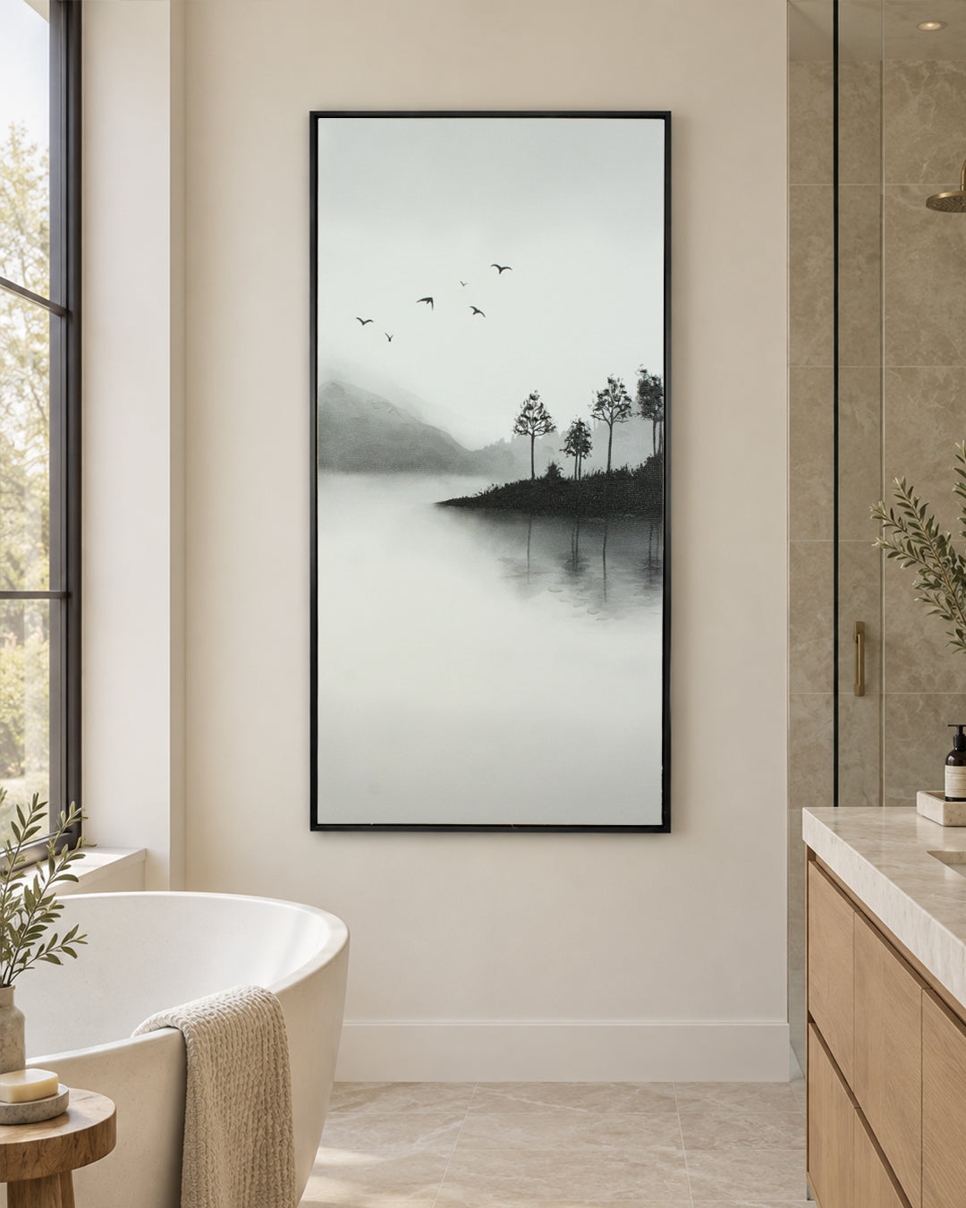 A Place Untouched monochrome lake wall art in a bathroom beside a freestanding bath