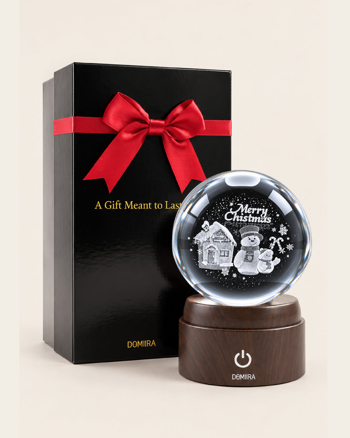 A Snowy Christmas crystal globe beside its ribbon-finished gift box