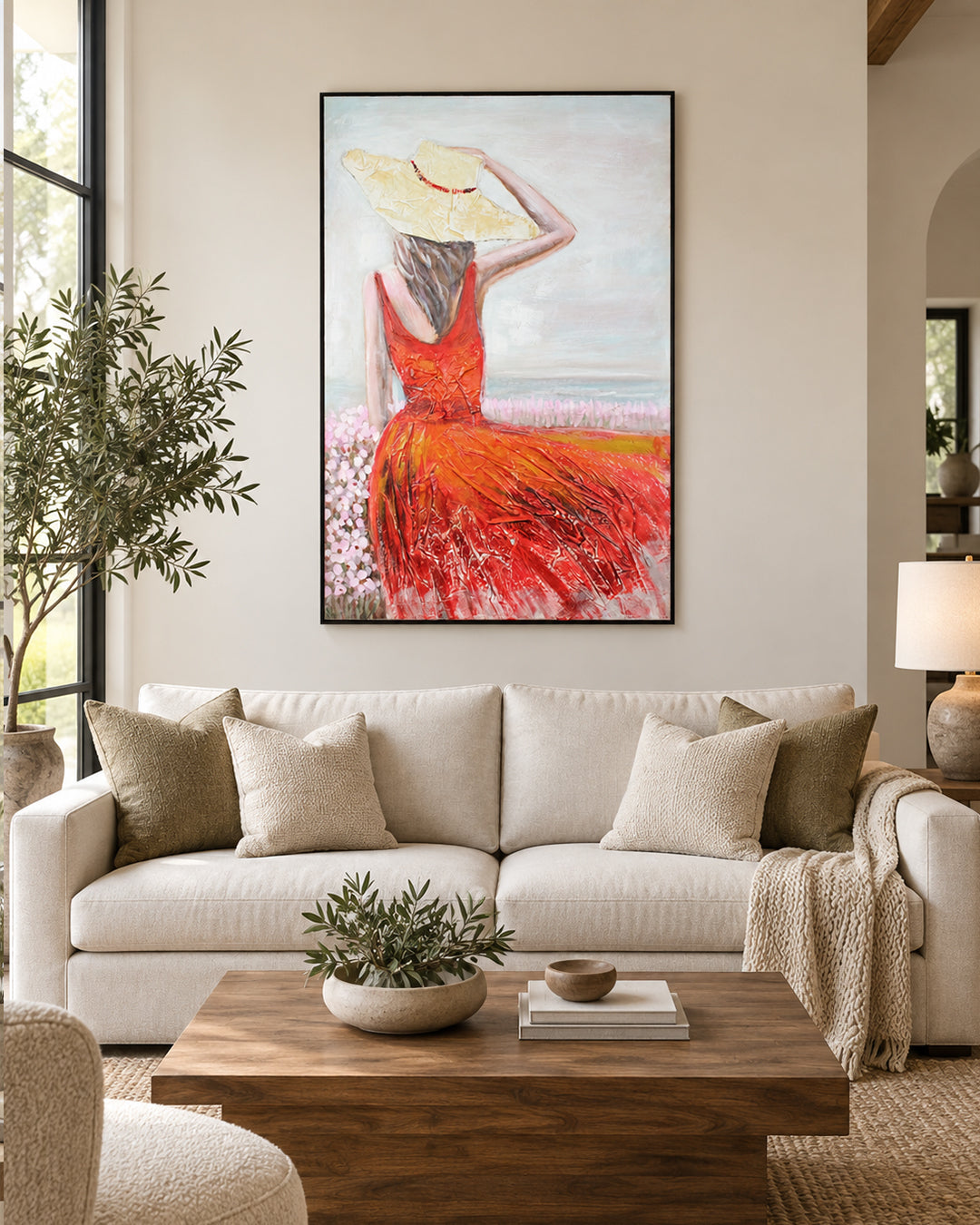 Crimson Shore woman in red dress painting above a sofa in a living room
