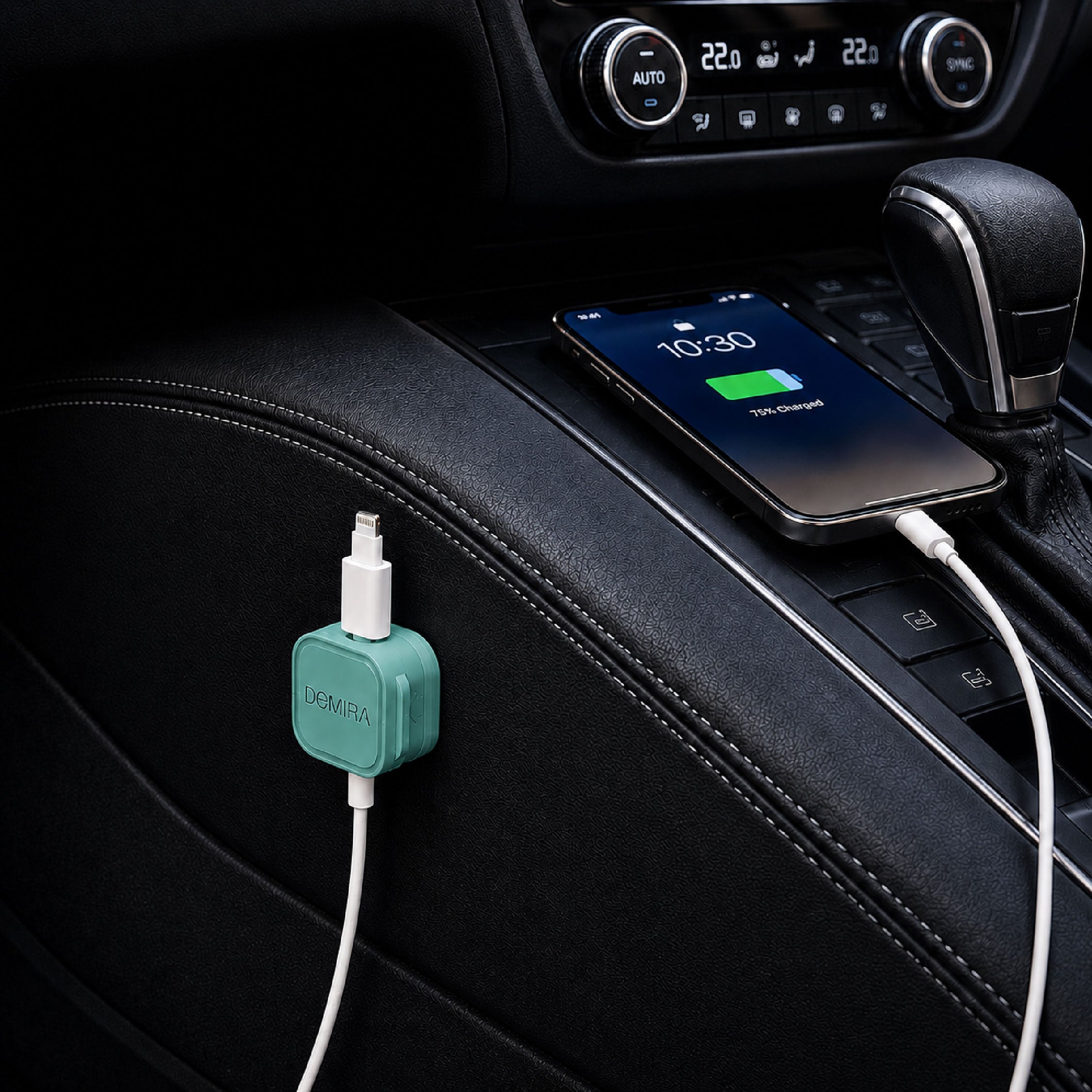 DOMIRA green magnetic cable holder clips used in a car to organise charging cables, USB cables and AUX cords.