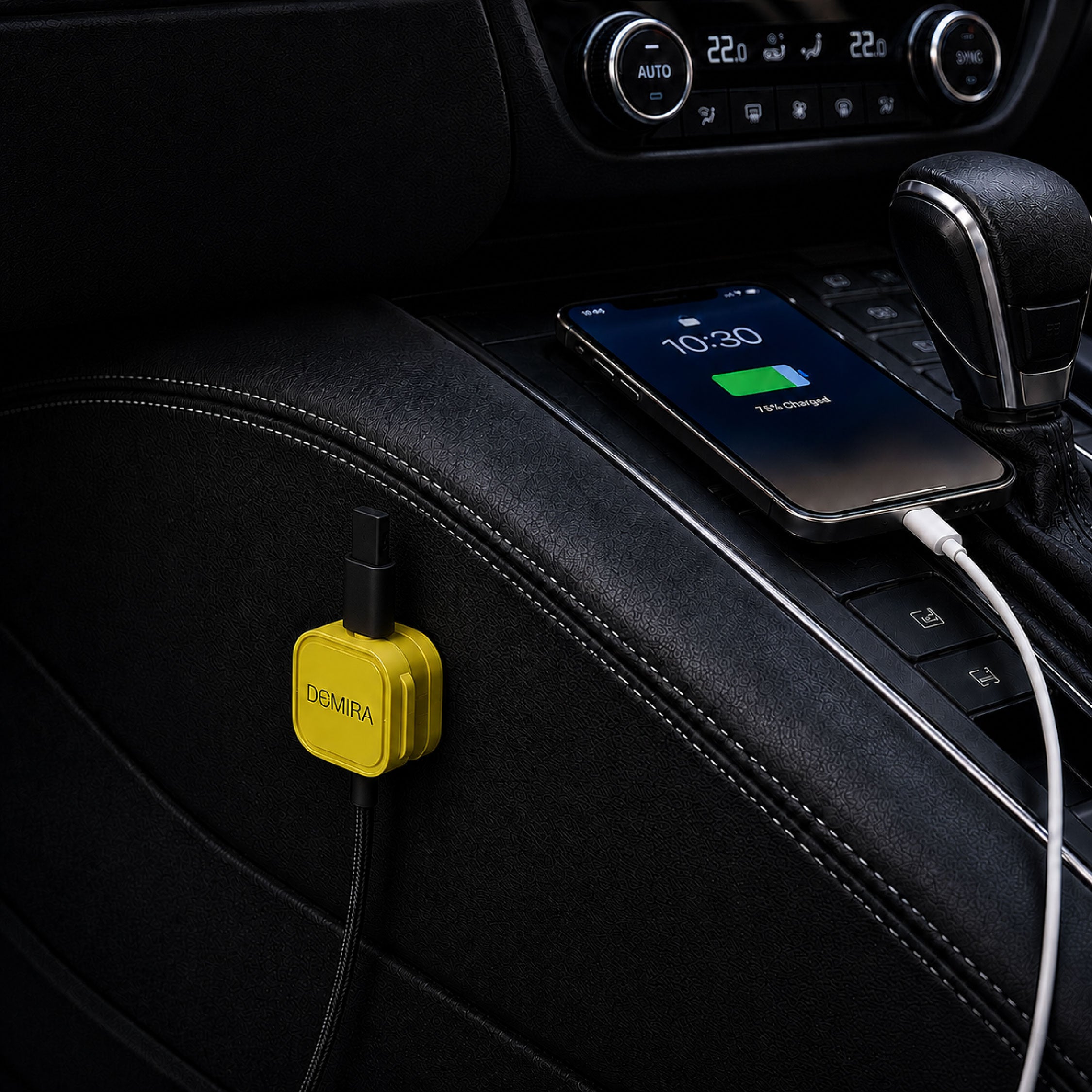 DOMIRA yellow magnetic cable holder clips used in a car to organise charging cables, USB cables and AUX cords.