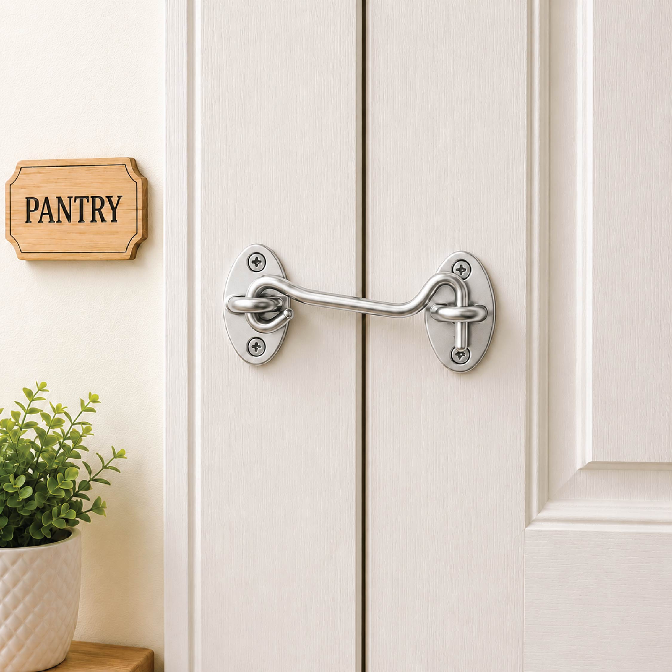 DOMIRA chrome hook and eye door
latch shown securing a wooden door
for reliable closure