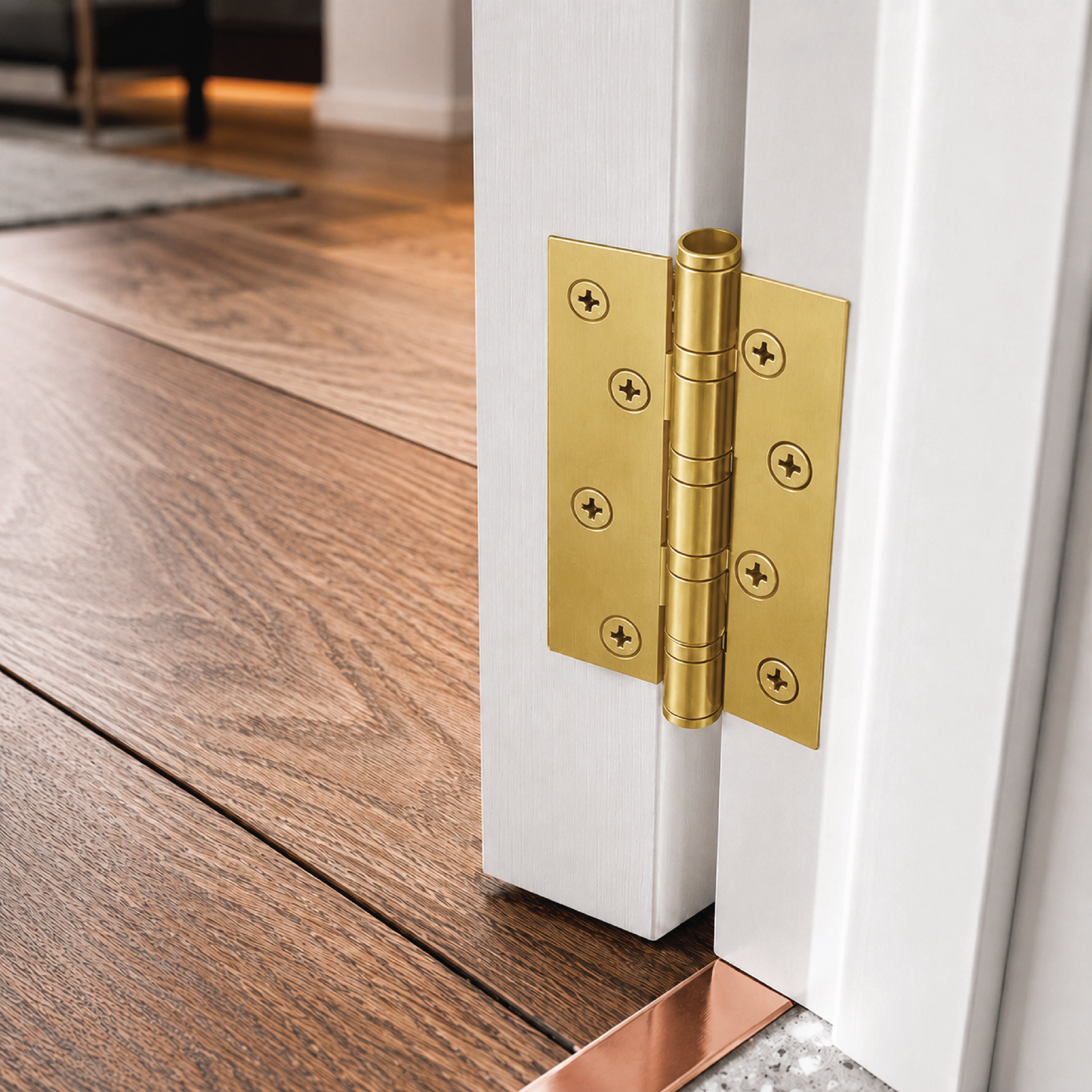 DOMIRA gold ball bearing door hinges
installed on an external timber door with
durable rust-resistant steel construction
suitable for residential and commercial use.