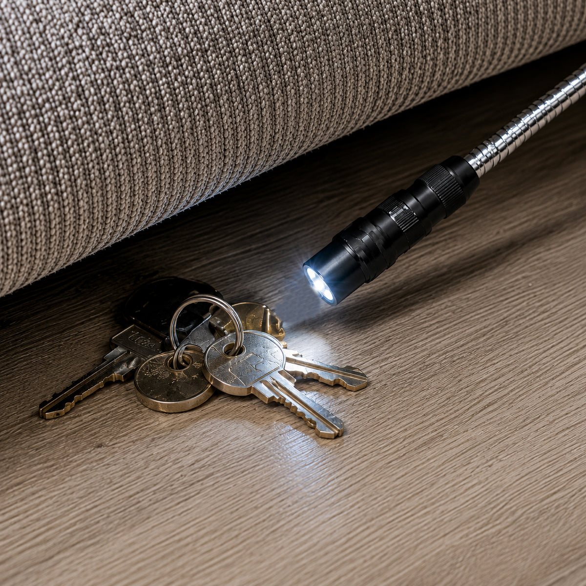 DOMIRA LED magnetic pickup tool
retrieving car keys from beneath a sofa
using the telescopic body, flexible
magnetic head and LED light.