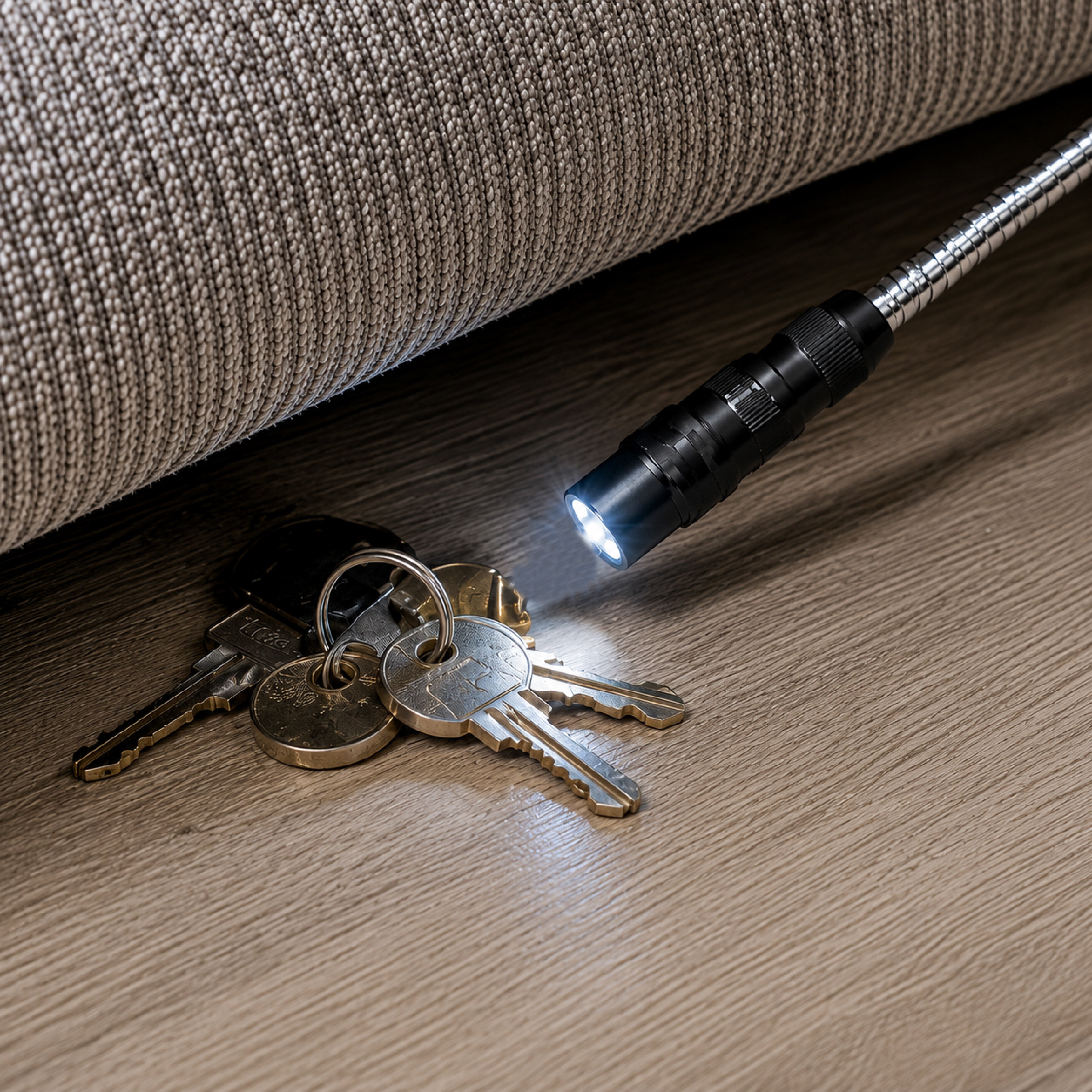 DOMIRA LED magnetic pickup tool
retrieving car keys from beneath a sofa
using the telescopic body, flexible
magnetic head and LED light.
