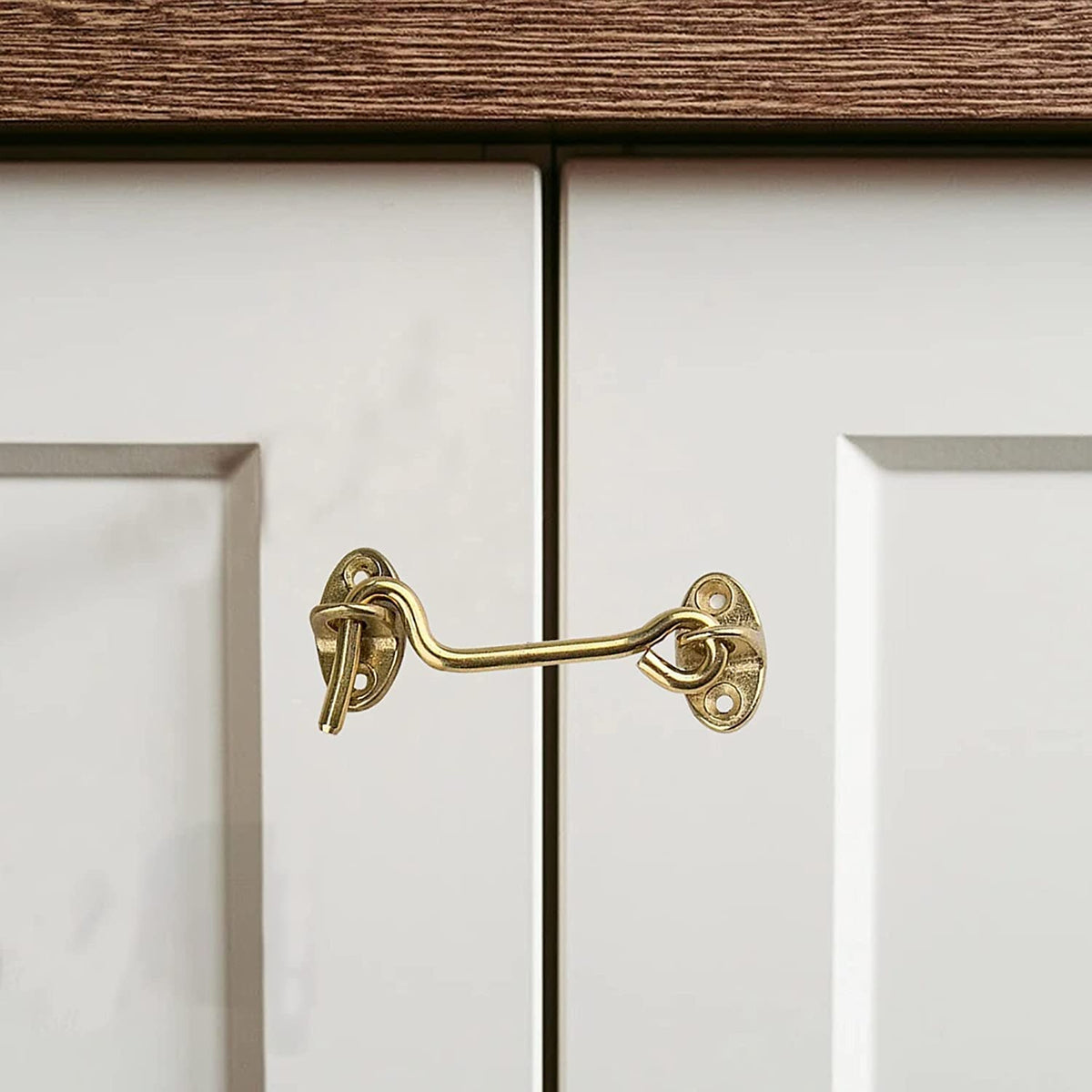 Golden hook and eye latch installed on a door