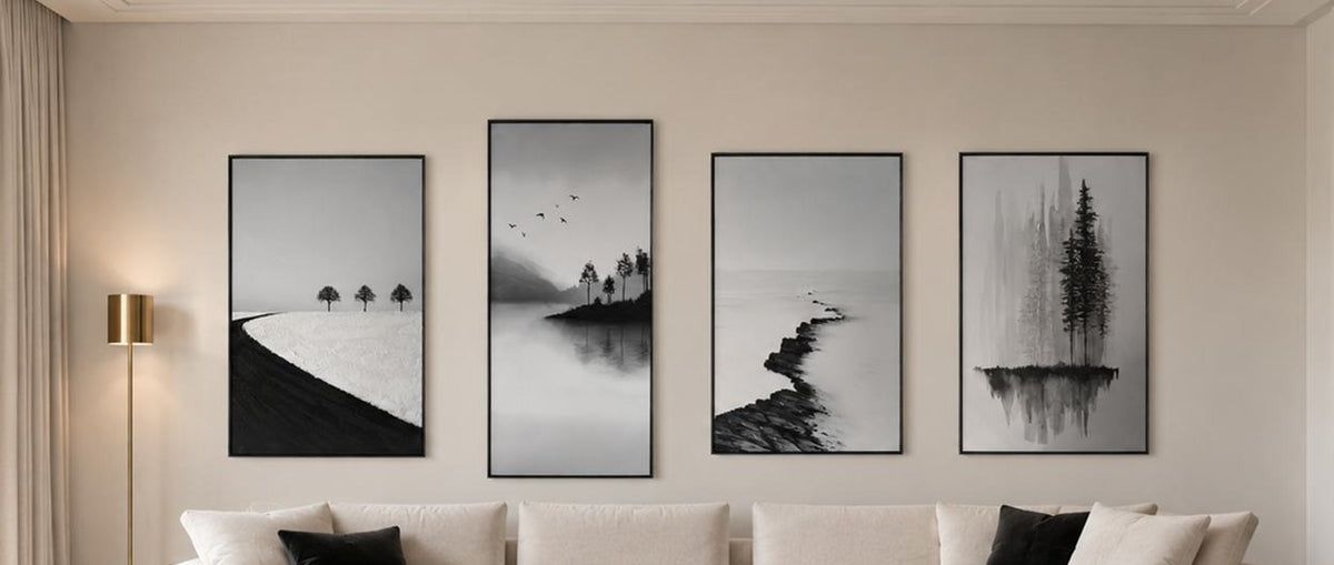 Four black and white hand embellished paintings above a cream sofa