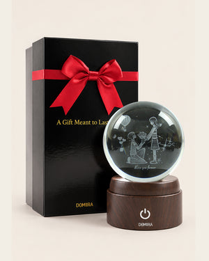 A Promise of Love crystal globe beside its ribbon-finished gift box