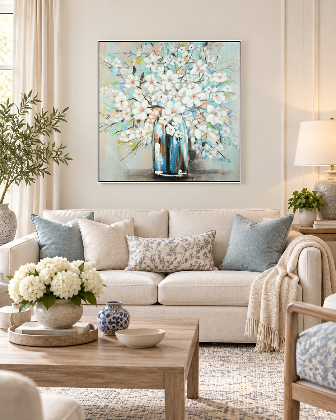 Magnolia Blue teal & white floral wall art above a sofa in a living room