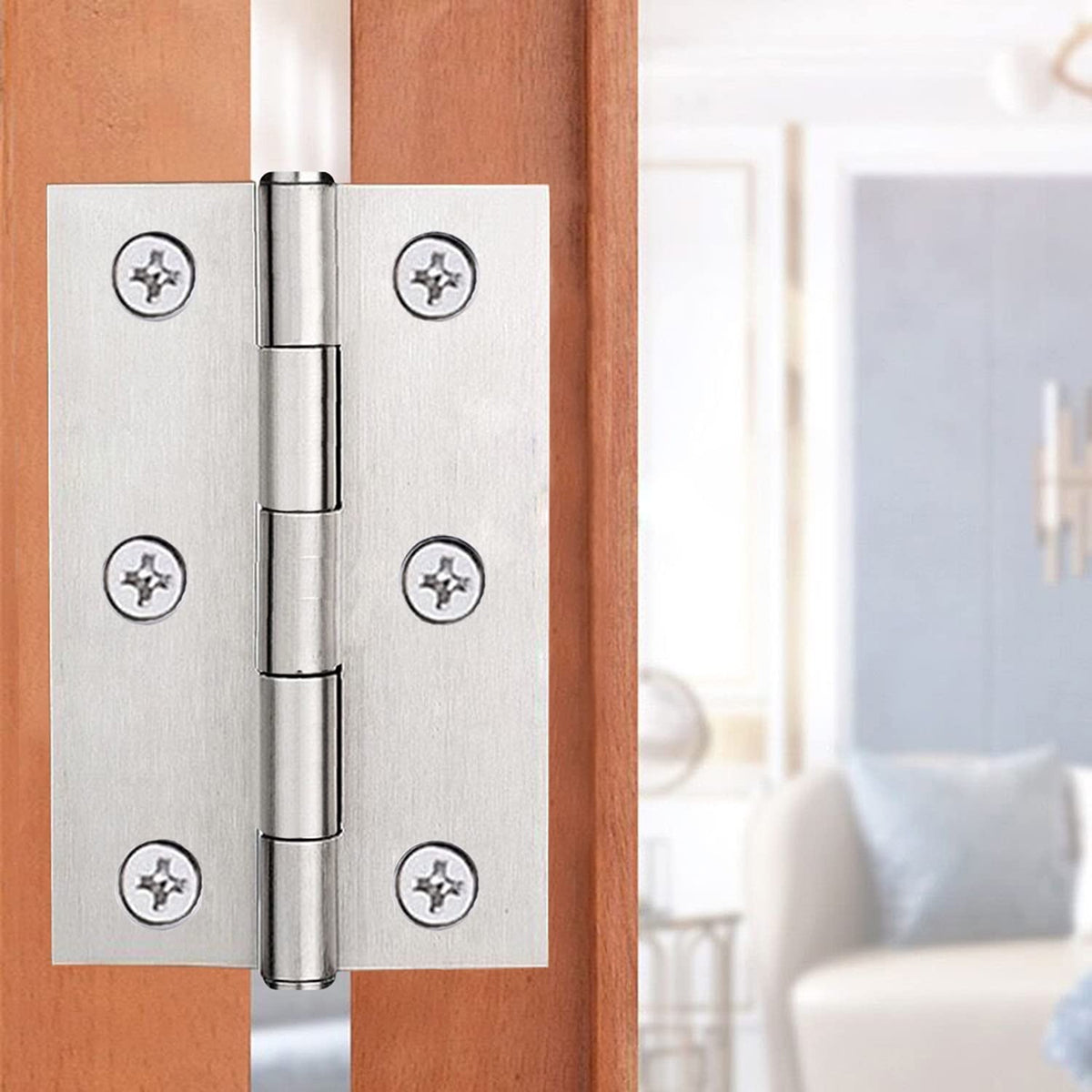 Silver 3 inch door hinges installed on a wooden door
