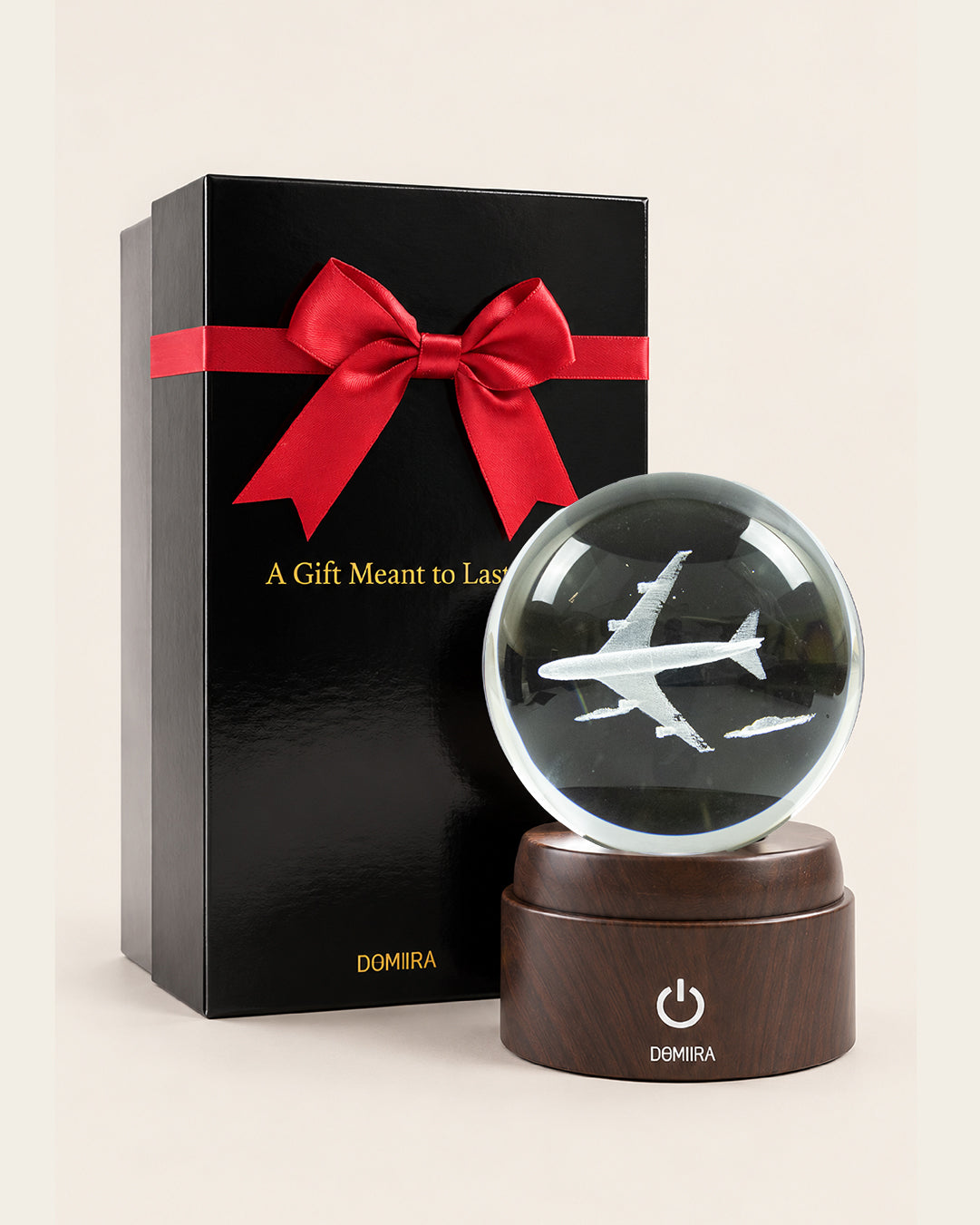 Chasing Horizons crystal globe beside its ribbon-finished gift box