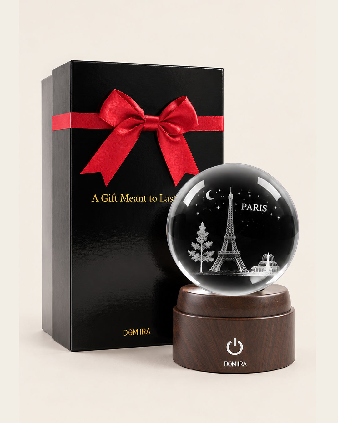 Paris Forever crystal globe beside its ribbon-finished gift box