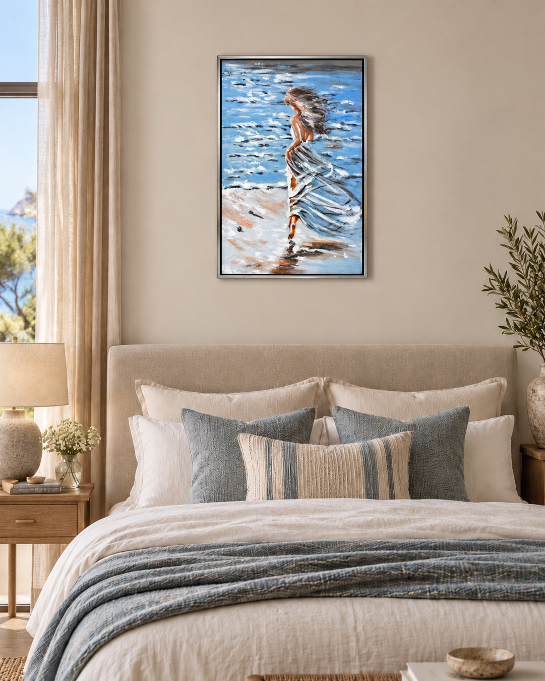 Untethered woman by the sea painting above a bed in a bedroom