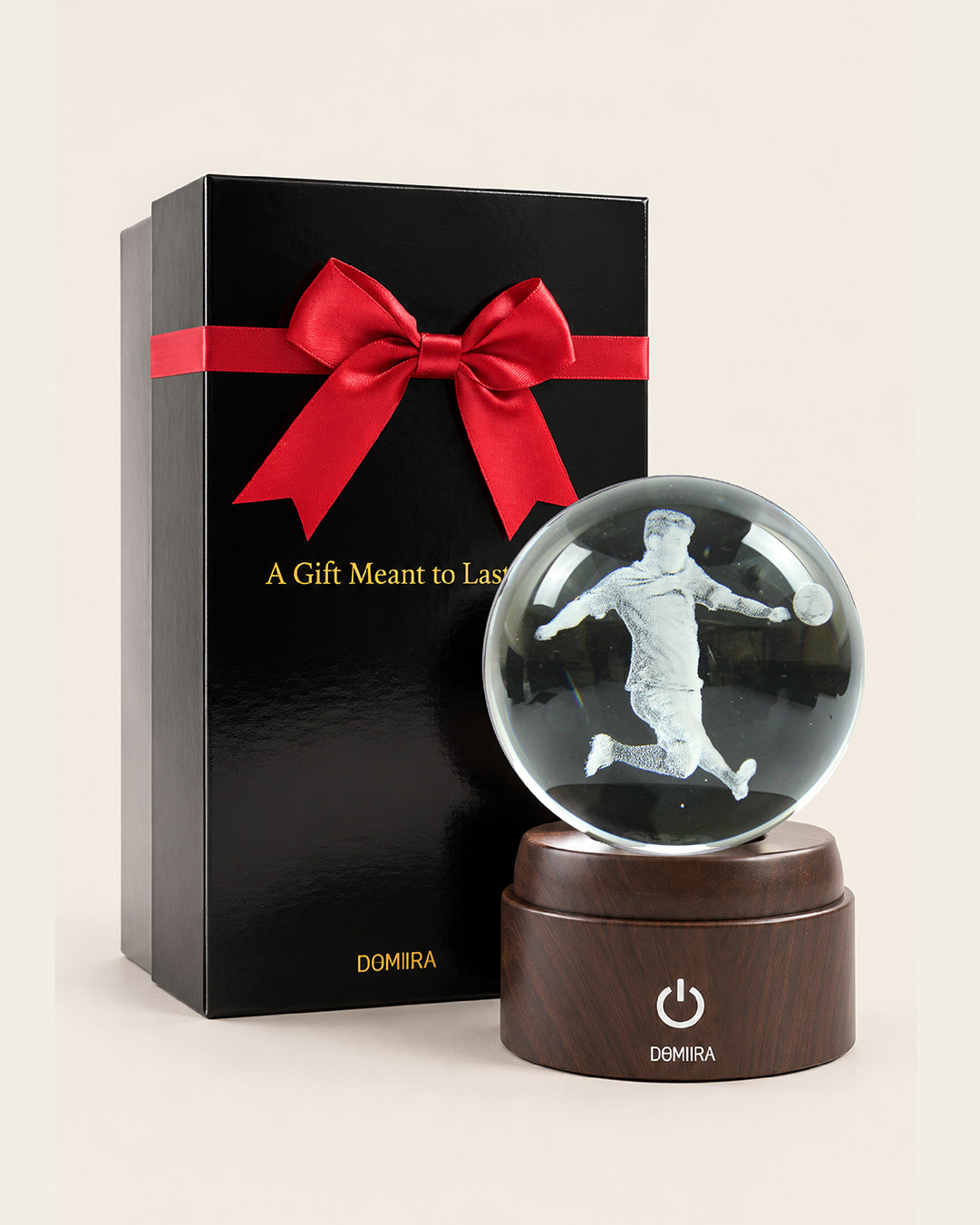 Victory Kick crystal globe beside its ribbon-finished gift box
